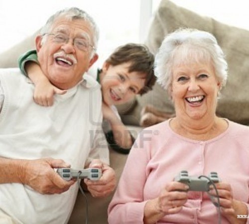 7715180-old-man-and-woman-playing-video-game-with-their-grandson-at-the-back-on-sofa1
