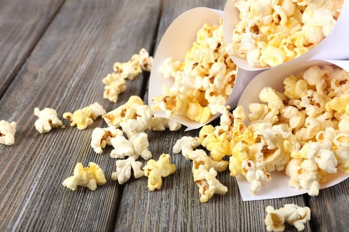 bigstock-Popcorn-on-wooden-table-close-68726650-716x477