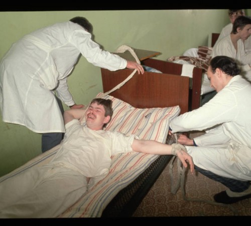 Workers restrain a patient at a hospital in Moscow, Russia on February 19, 1992.
